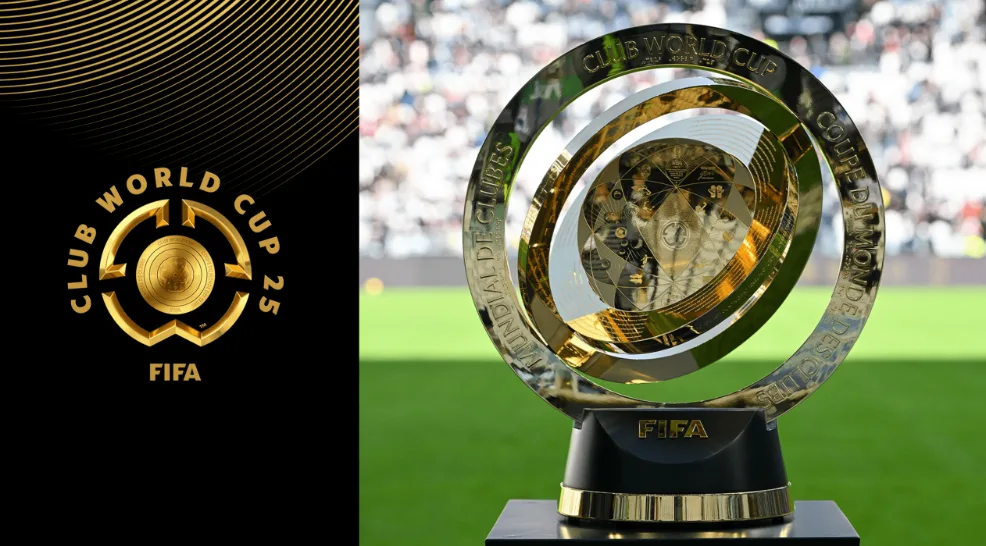 FIFA Club World Cup 2025 logo on the left and the new tournament trophy displayed on a football pitch in the background